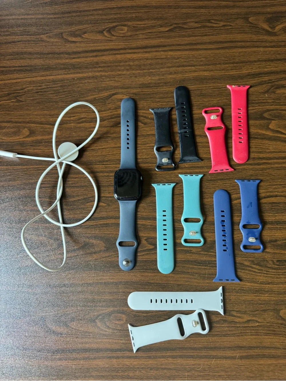 Apple Watch with Assorted Silicone Bands in Black, Red, Blue, Teal, White
